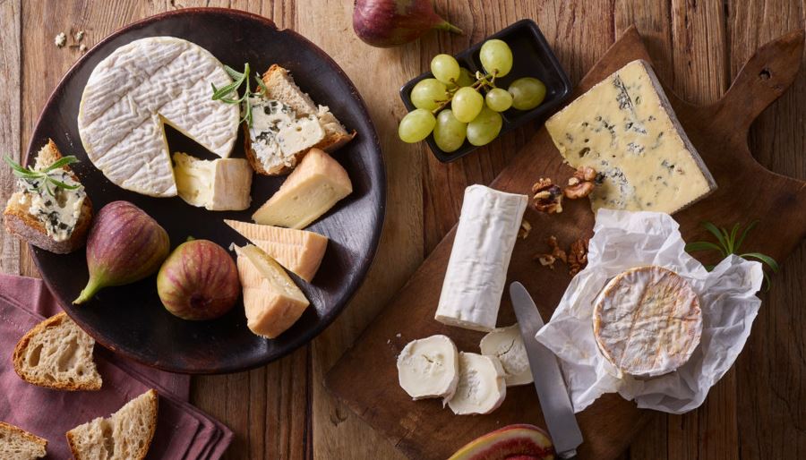 Soft cheeses and fruits on a platter