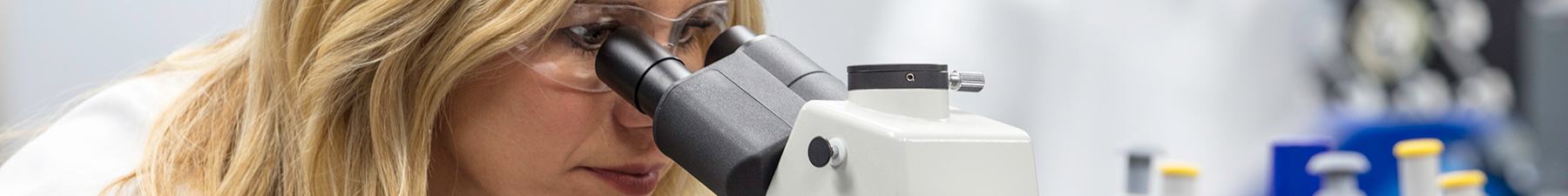 Woman looking into a microscope