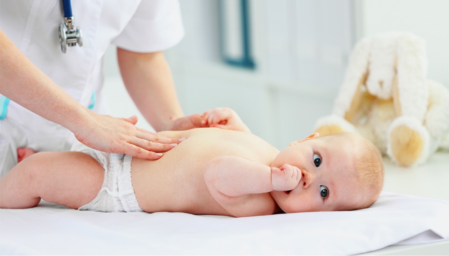 Baby being examined for stomach problems