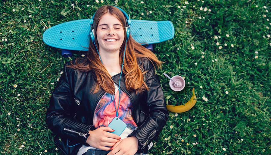 Girl resting on a skateboard with yogurt